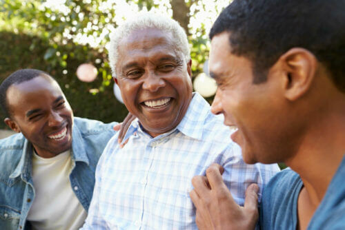 Smiling men of different ages in the park